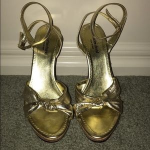 Pair of gold open toed ankle strap wedges